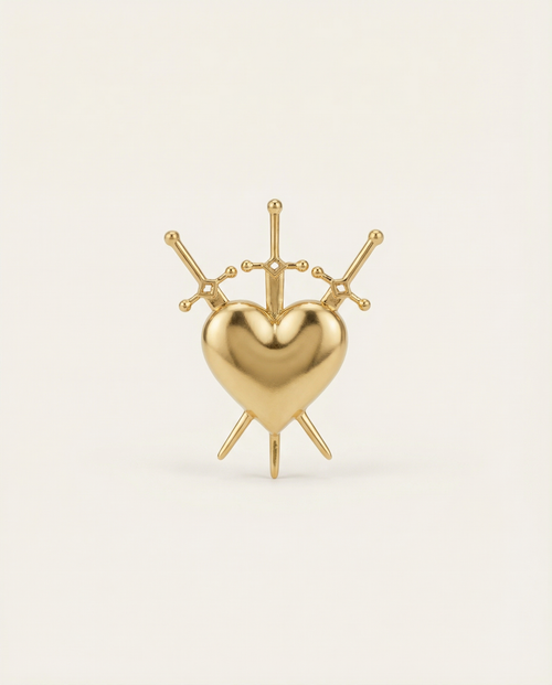 Gold heart-shaped ring with 3 swords on a light beige background