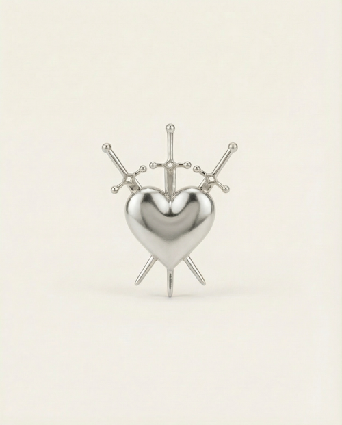 Silver heart-shaped ring with 3 swords design on a beige background