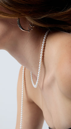 Close-up of a person wearing a freshwater pearl necklace 