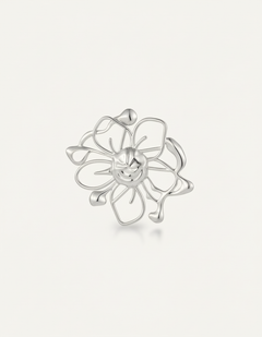 Silver floral earring on a light gray background