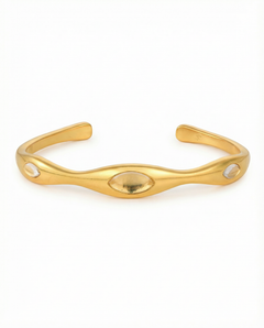 Gold bracelet on a white background selenova